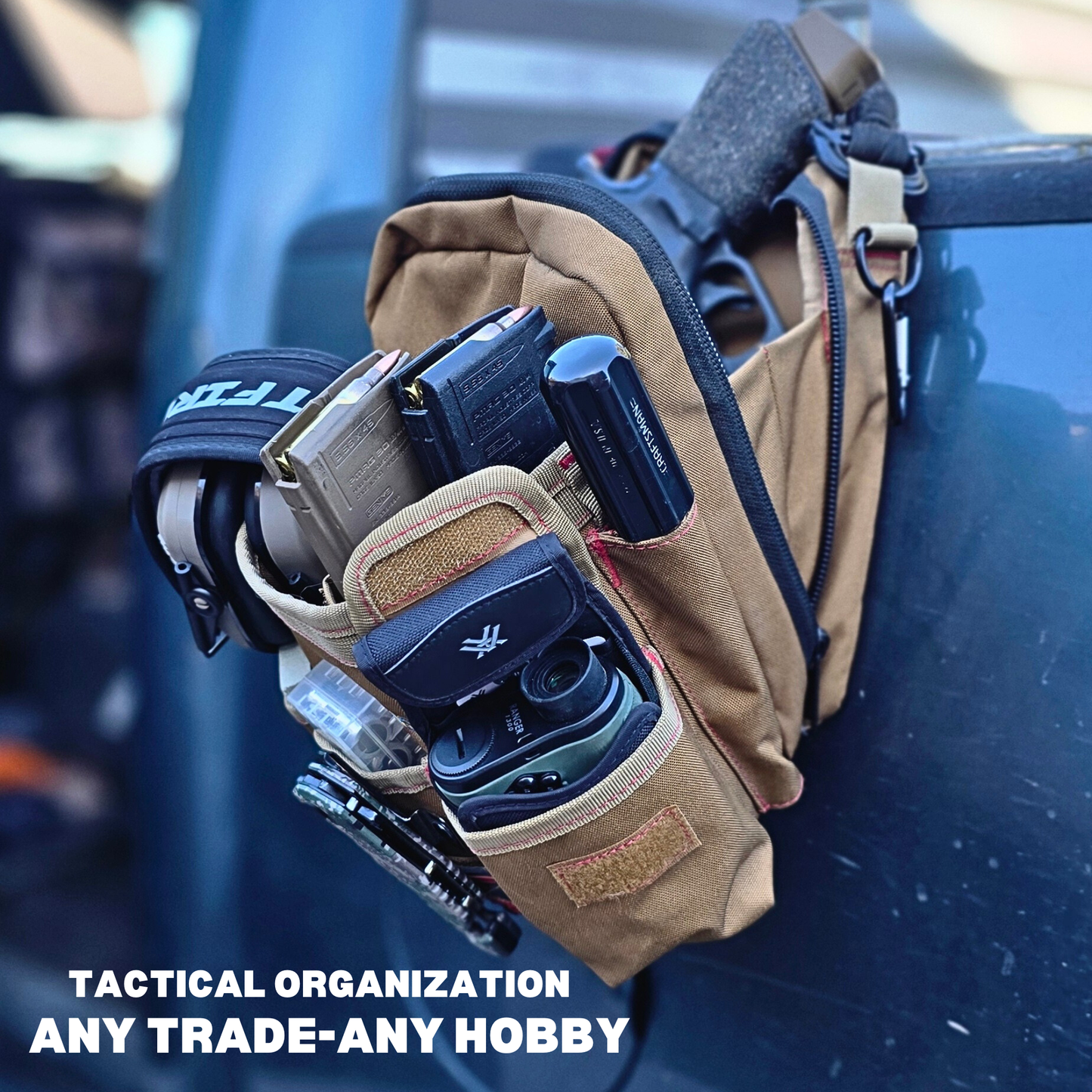 Tactical pouch with various tools and equipment on a reflective surface